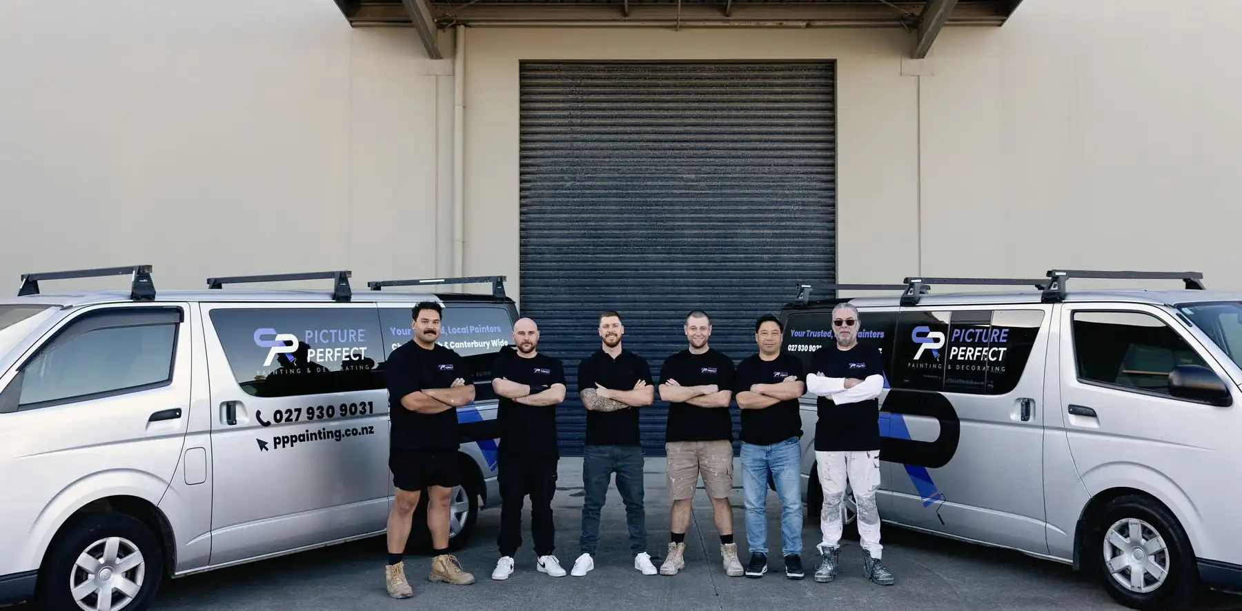 The PP Painting team in front of their branded vans in Christchurch