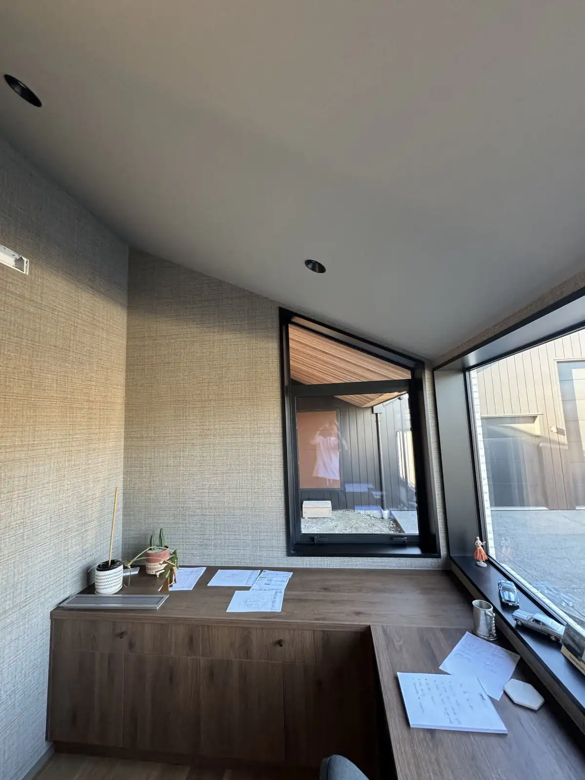 Home office nook with textured walls and a view to the courtyard