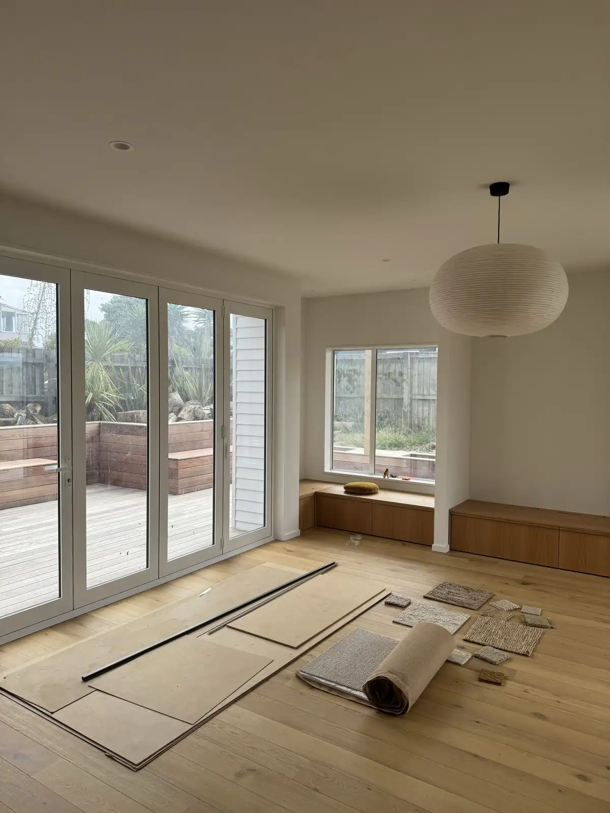 Upstairs living space with timber floors and white walls