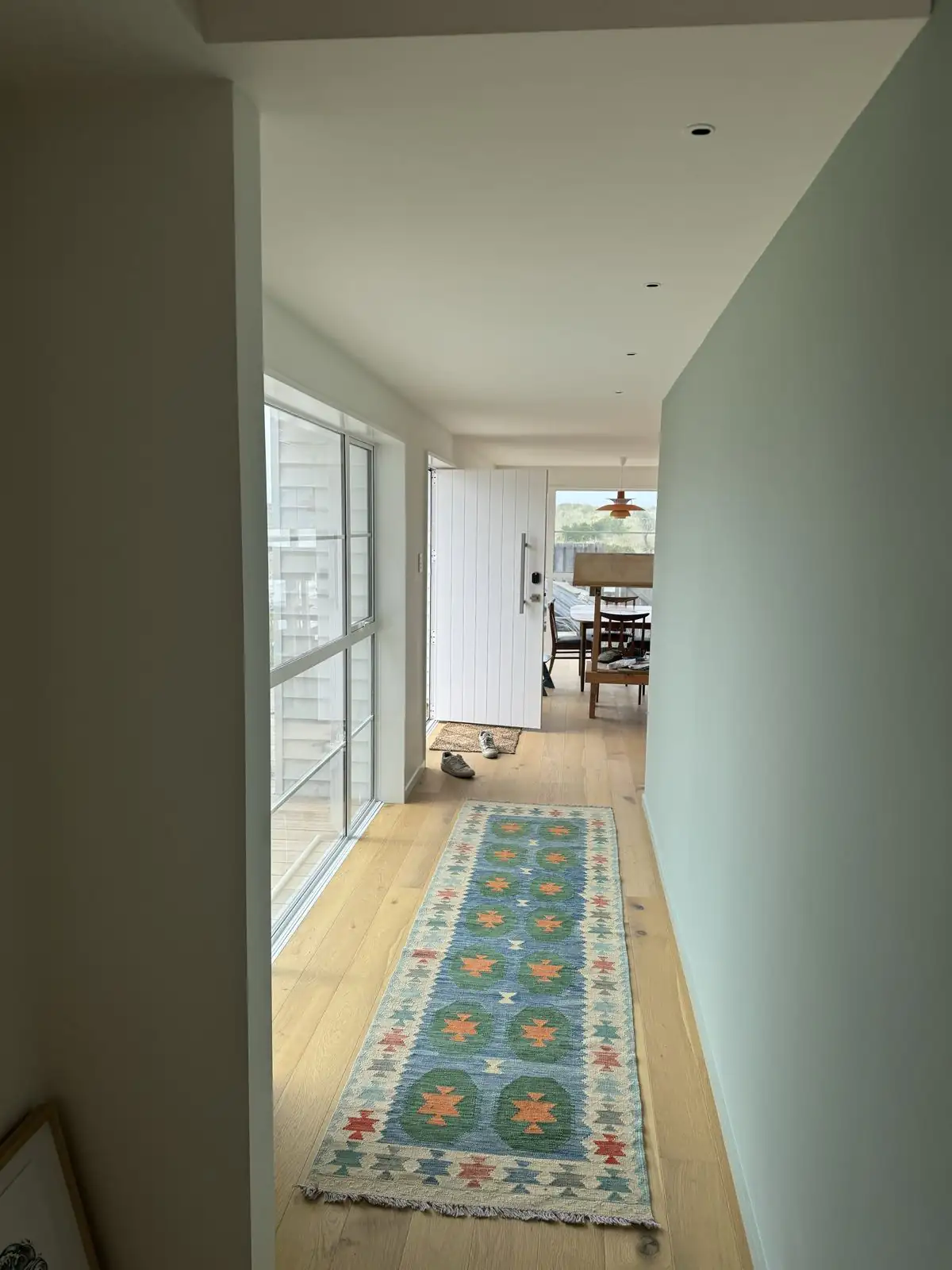 Pale mint hallway leading through to the living area