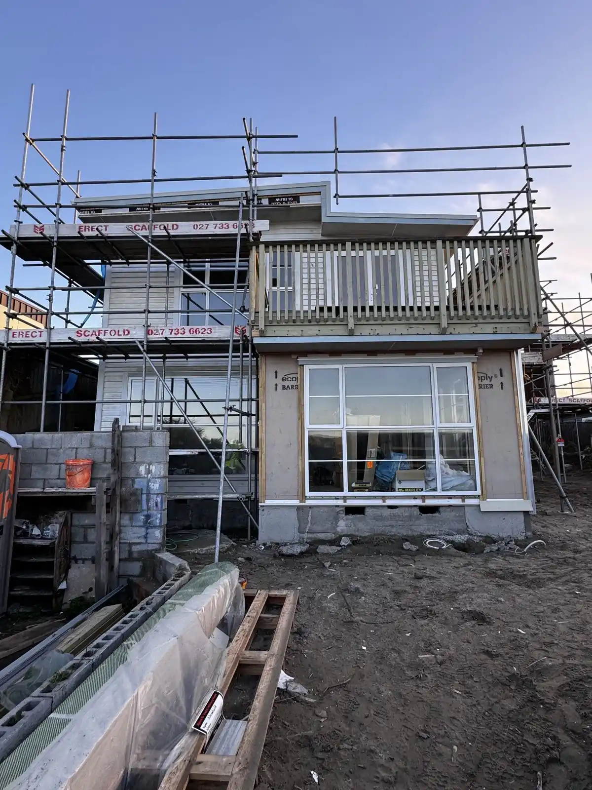 The house wrapped in scaffolding before painting began
