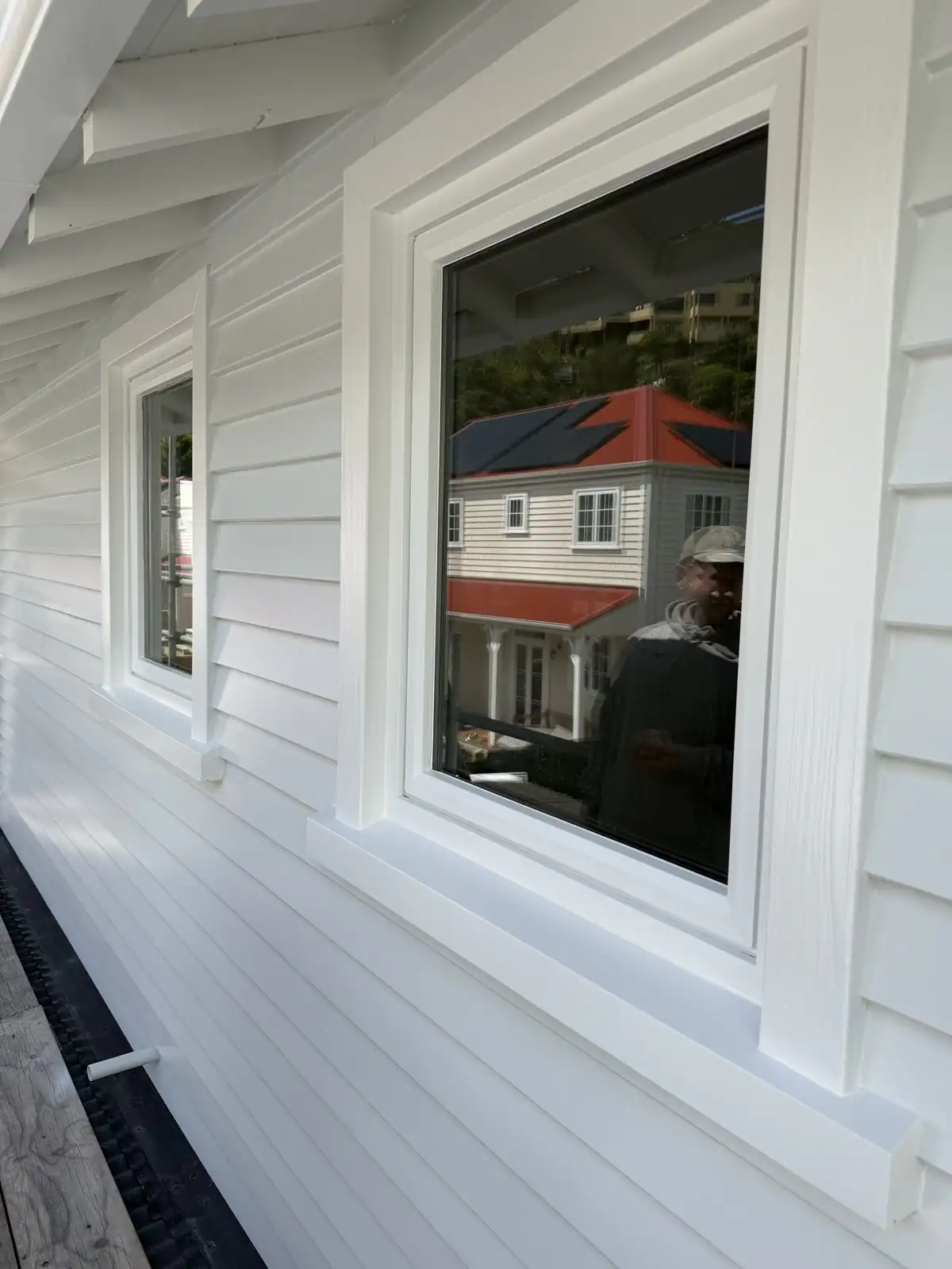 Upper-storey window with a view across the Sumner rooftops