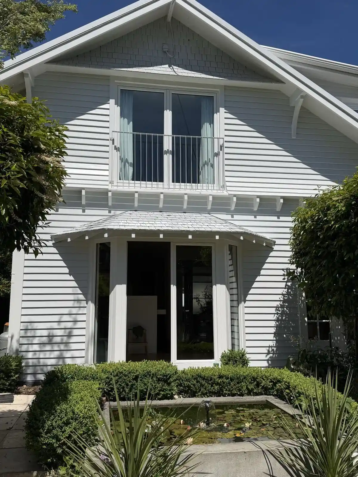 Front of the house with its upstairs balcony and covered porch
