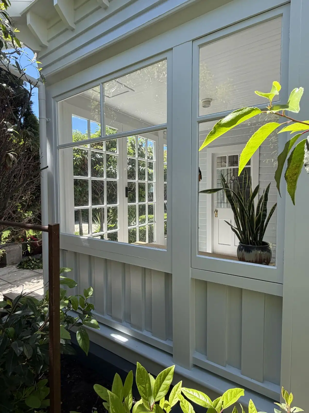 The multi-pane sunroom on the front of the house