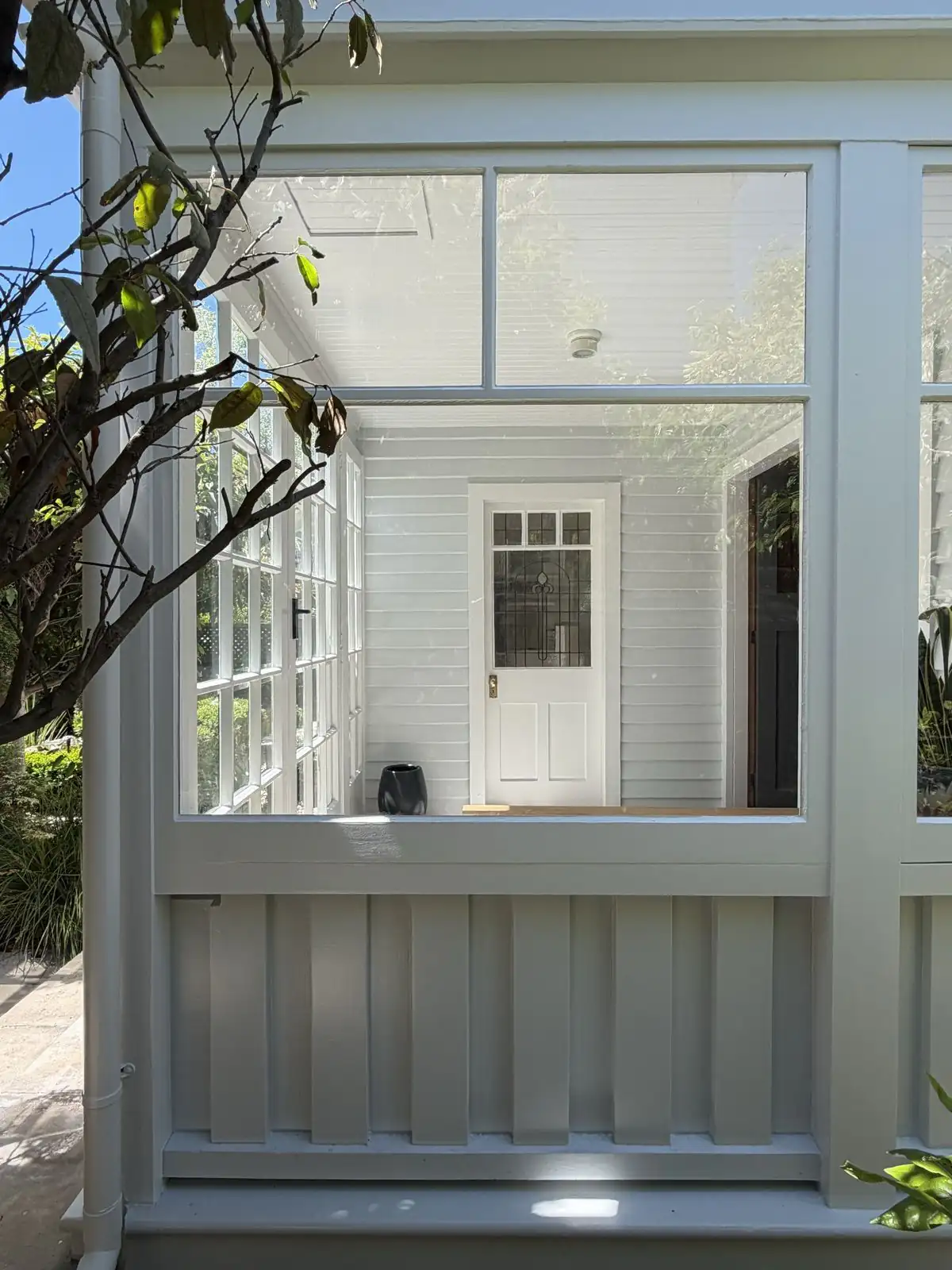 Sunroom windows and the front door beyond