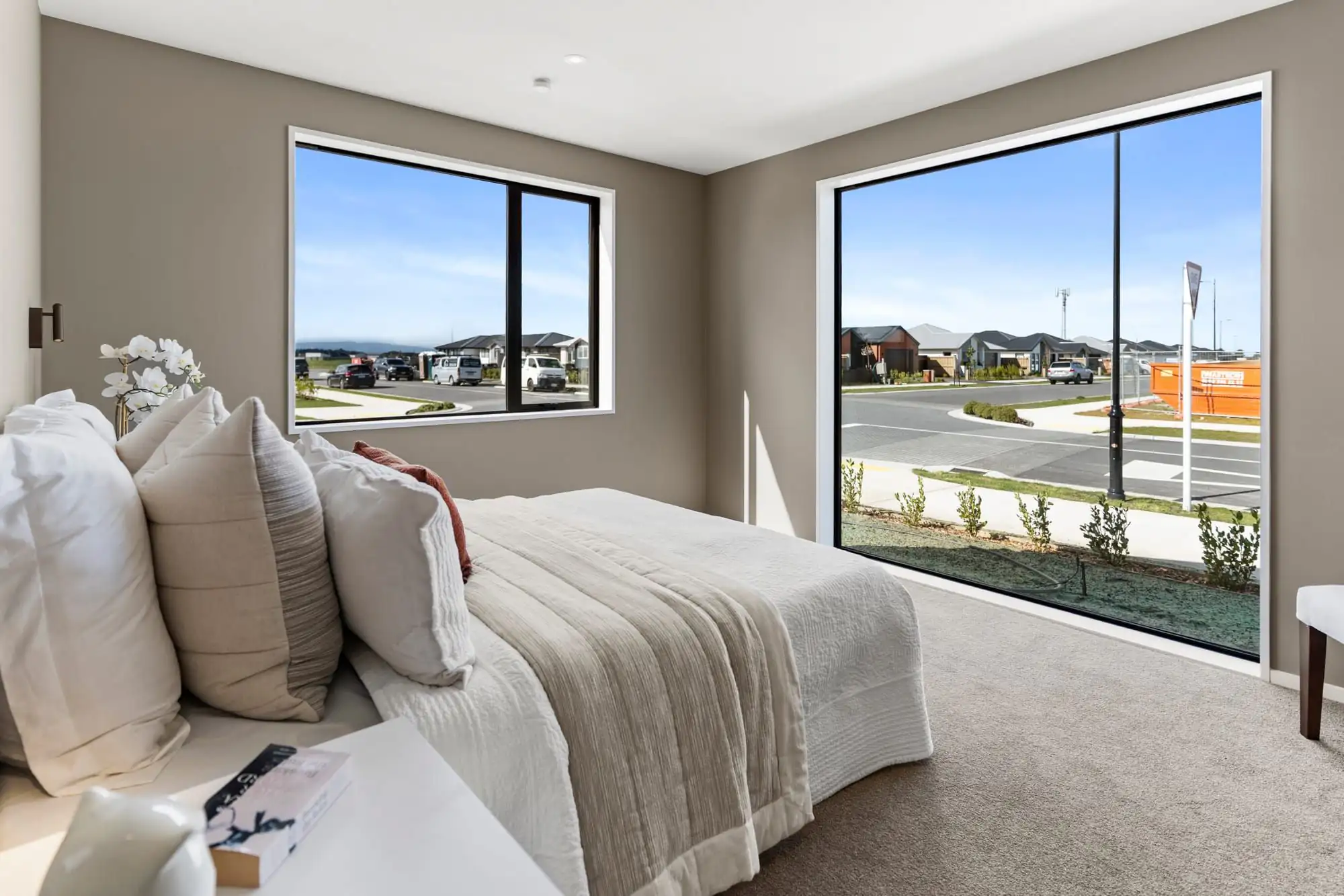 Bedroom with large corner windows looking out over the subdivision