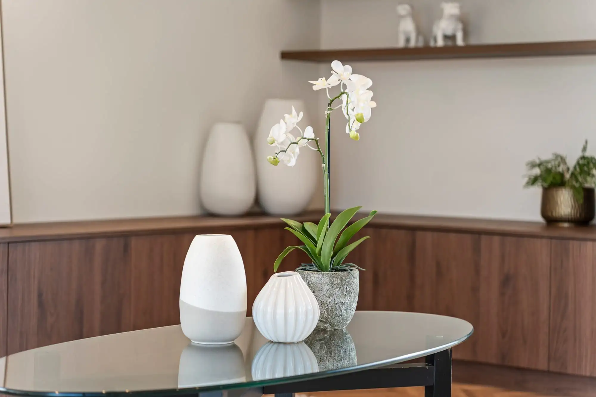 Detail of the living room shelving and styled vases against greige walls