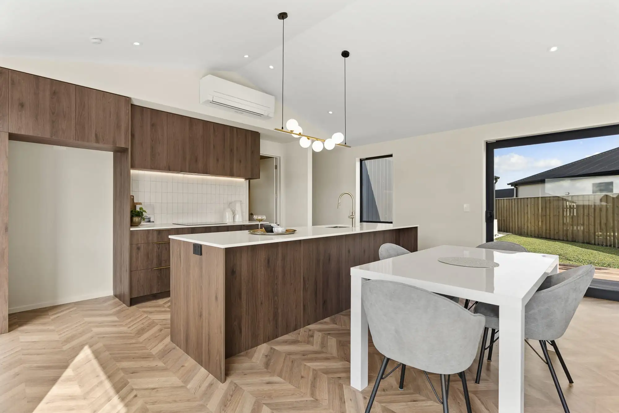 Kitchen and dining area with timber cabinetry and pendant lights