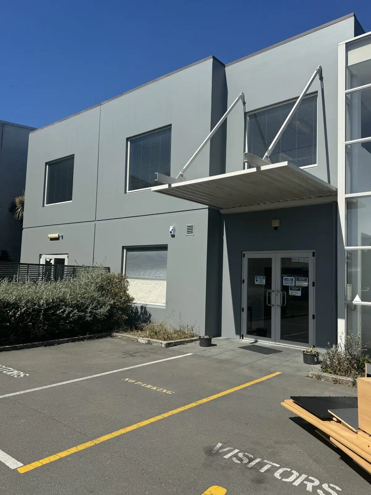 Grey two-storey office building with fresh exterior paintwork