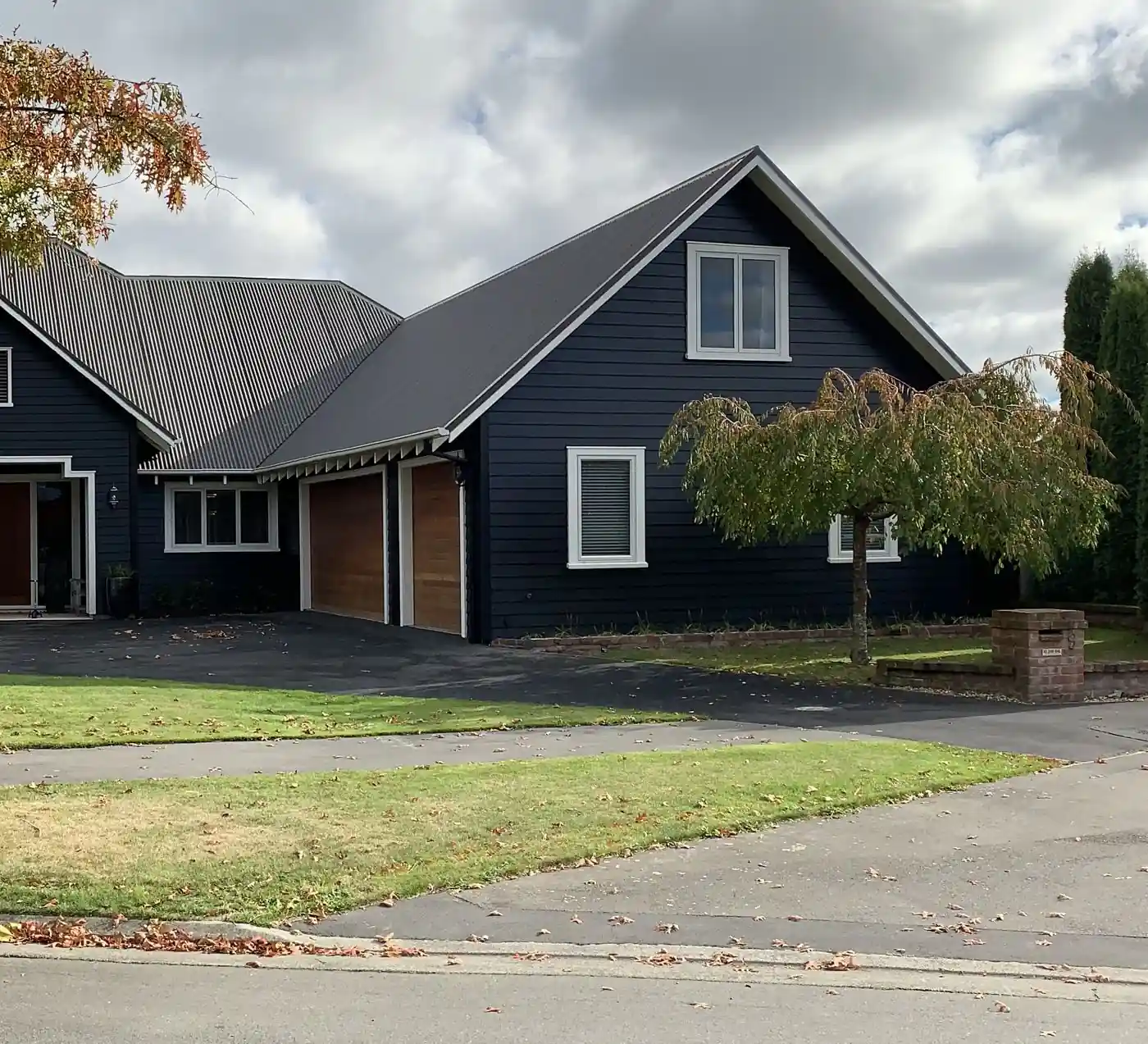 Charcoal gabled home with a dark long-run iron roof in Christchurch